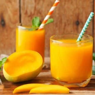 carrot mango juice in two glasses.