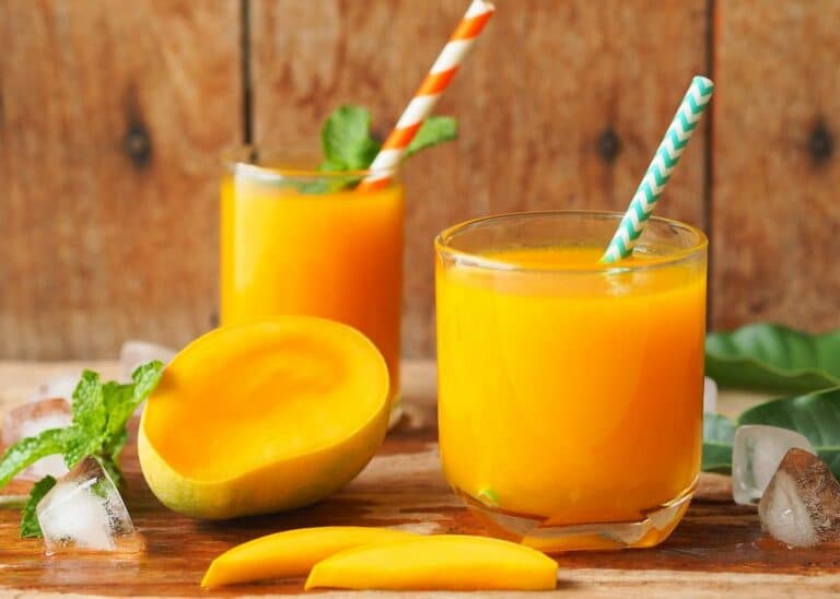 carrot mango juice in two glasses.