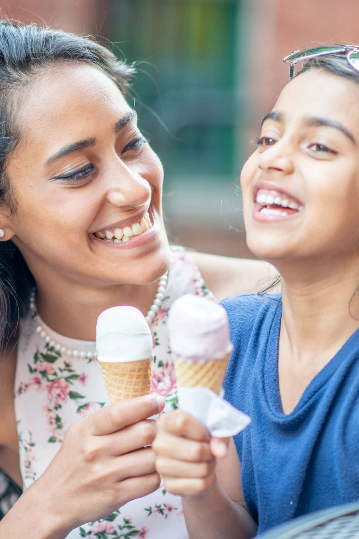 a mother and child enjoying an ice cream cone.