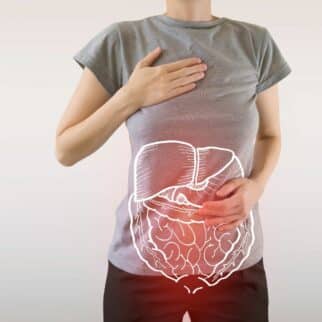 an illustration of a digestive tract on a photo of a woman holding her abdomen.
