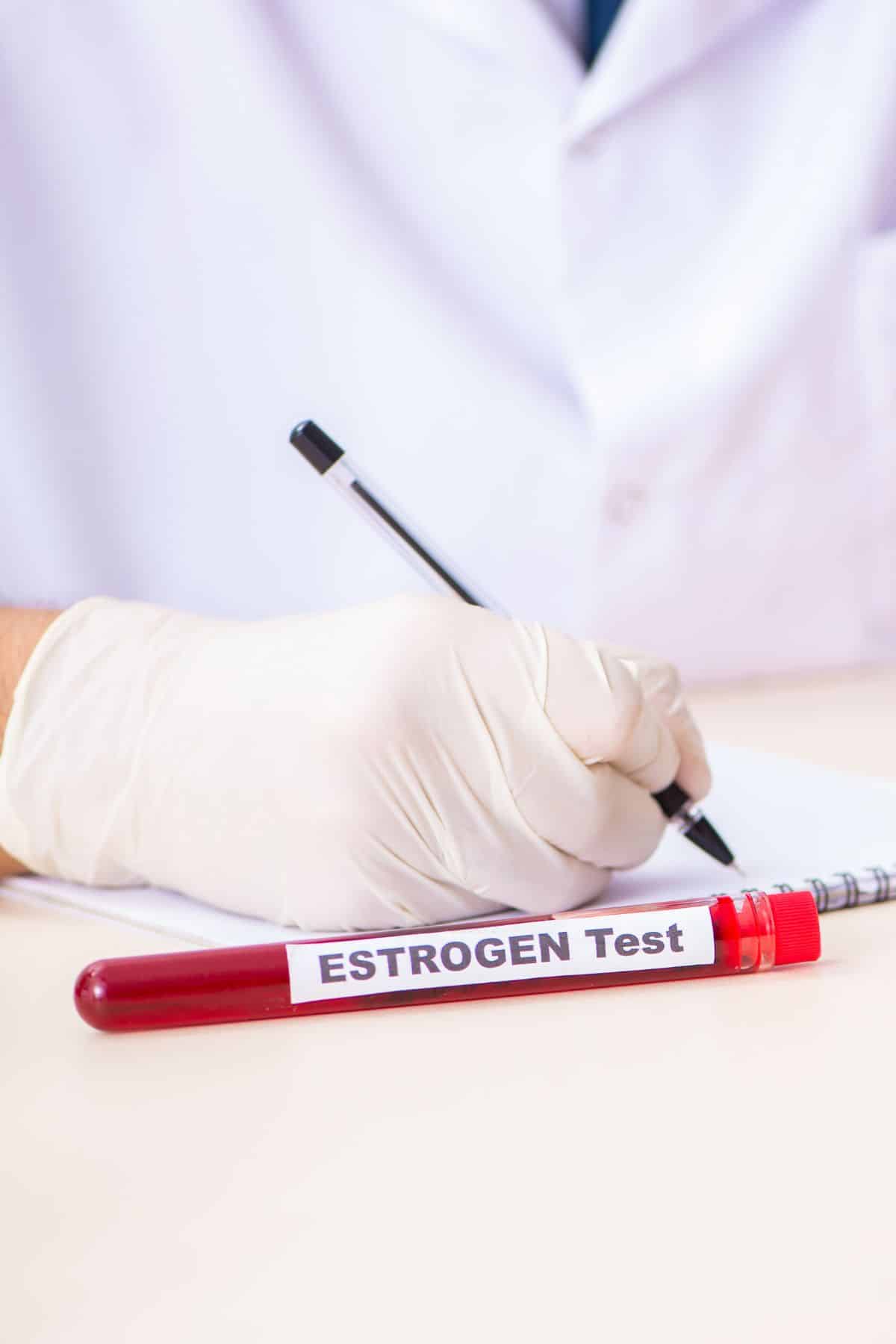 a vial in front of a doctor labeled "estrogen test".