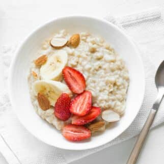 a bowl of oatmeal topped with fruit.