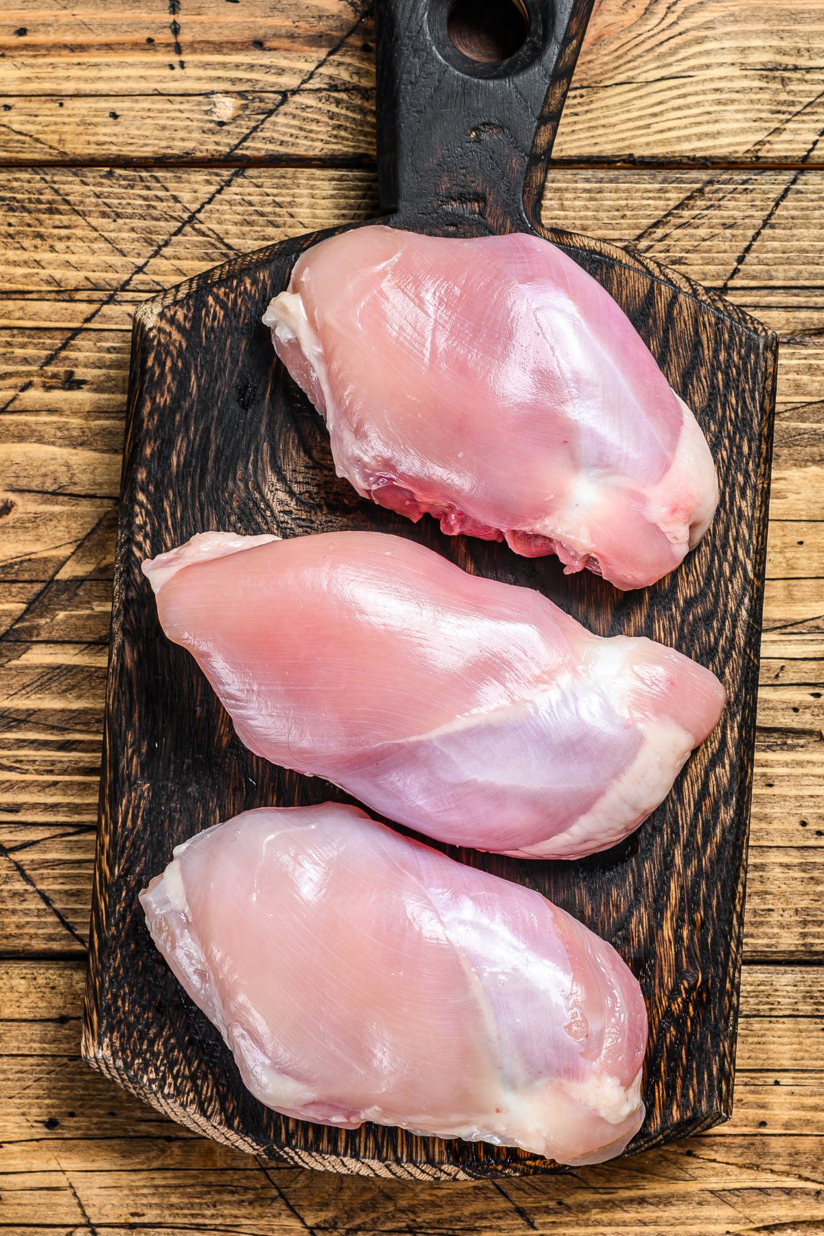 raw chicken on a cutting board.