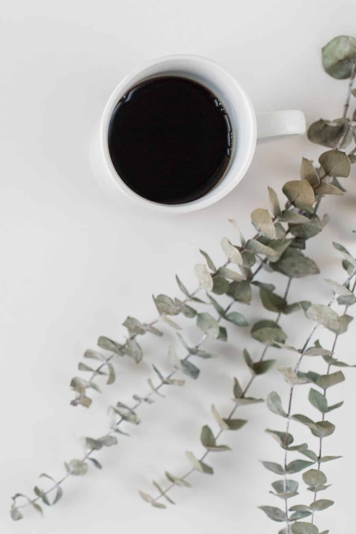 coffee in a white mug on a table.