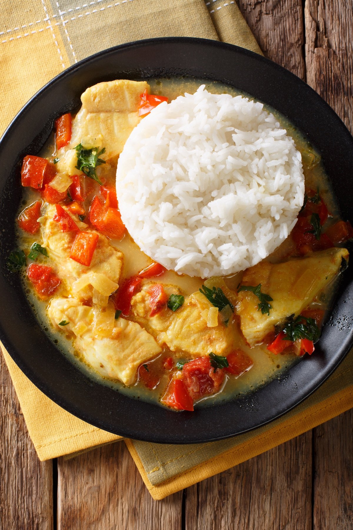 instant pot mahi mahi served in black bowl with rice.