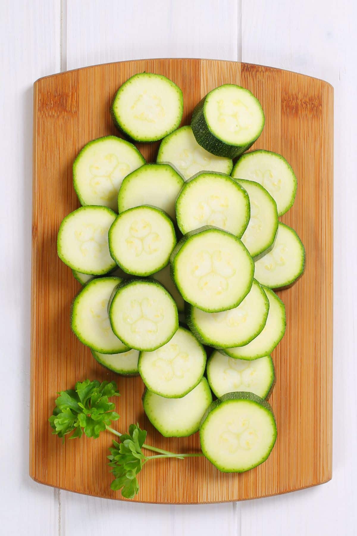 sliced zucchini on cutting board.