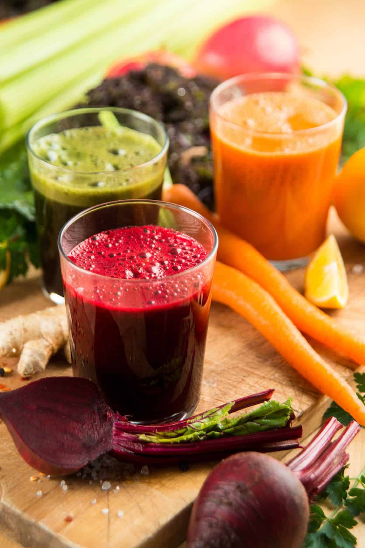three vegetables juices on table for cleanse.