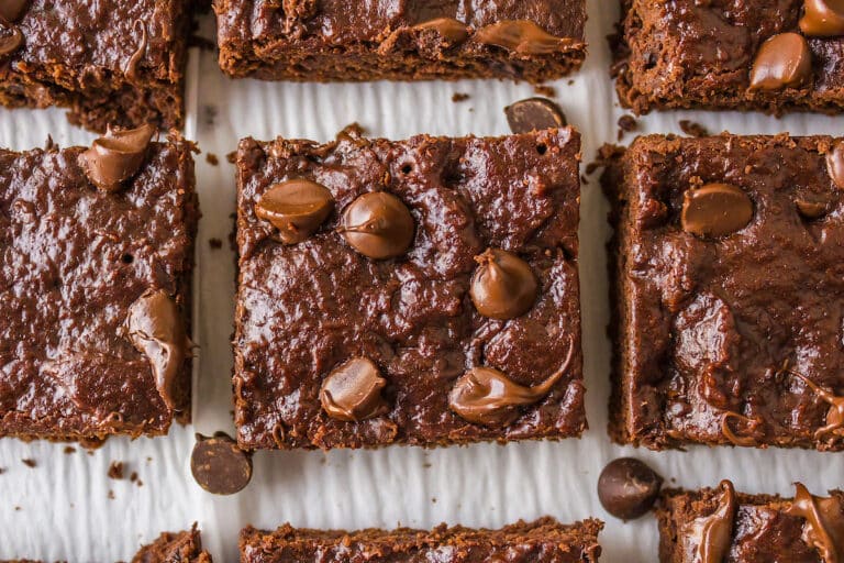 several dairy-free brownies on parchment paper.