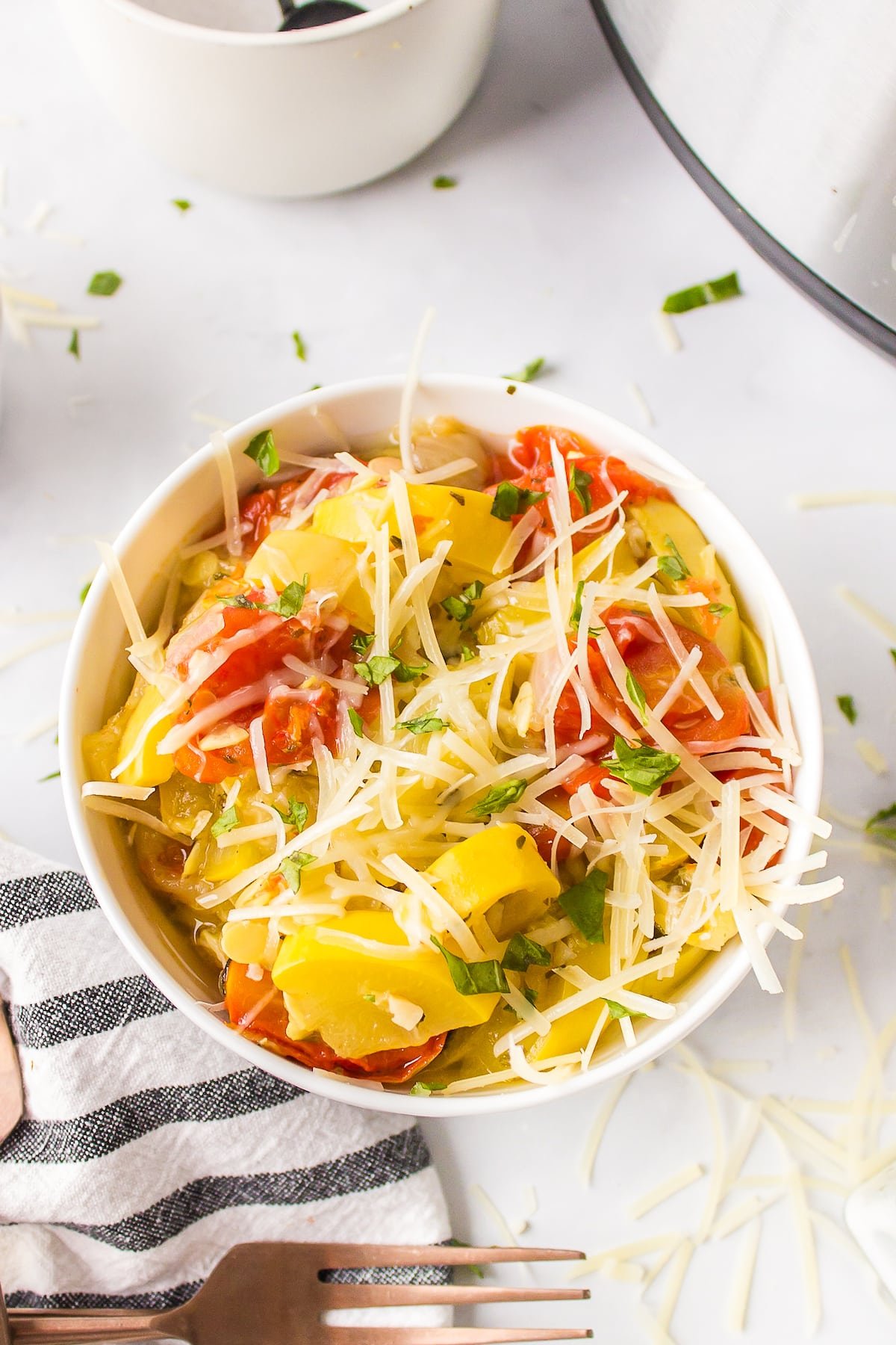 a bowl of instant pot yellow squash and tomatoes.