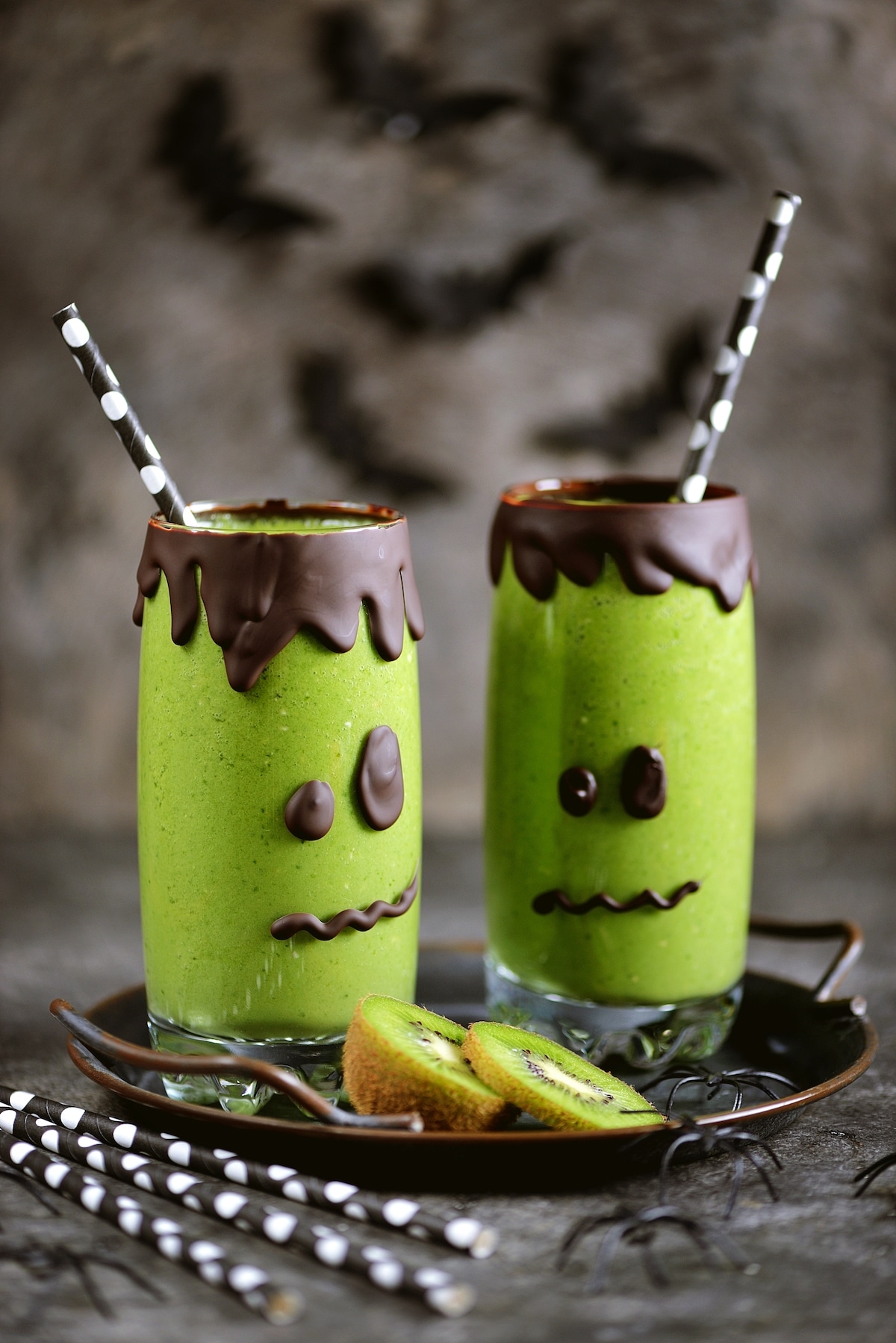 green smoothie in halloween themed glasses.