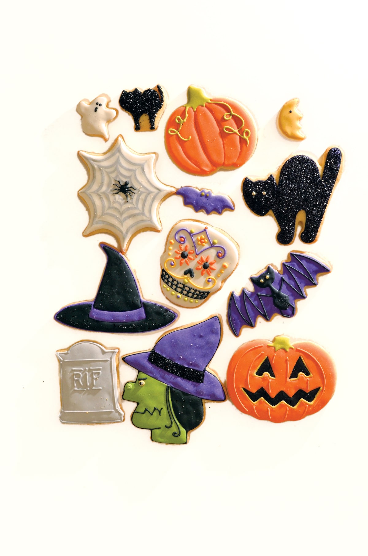 assortment of adorable Halloween cookies on table.