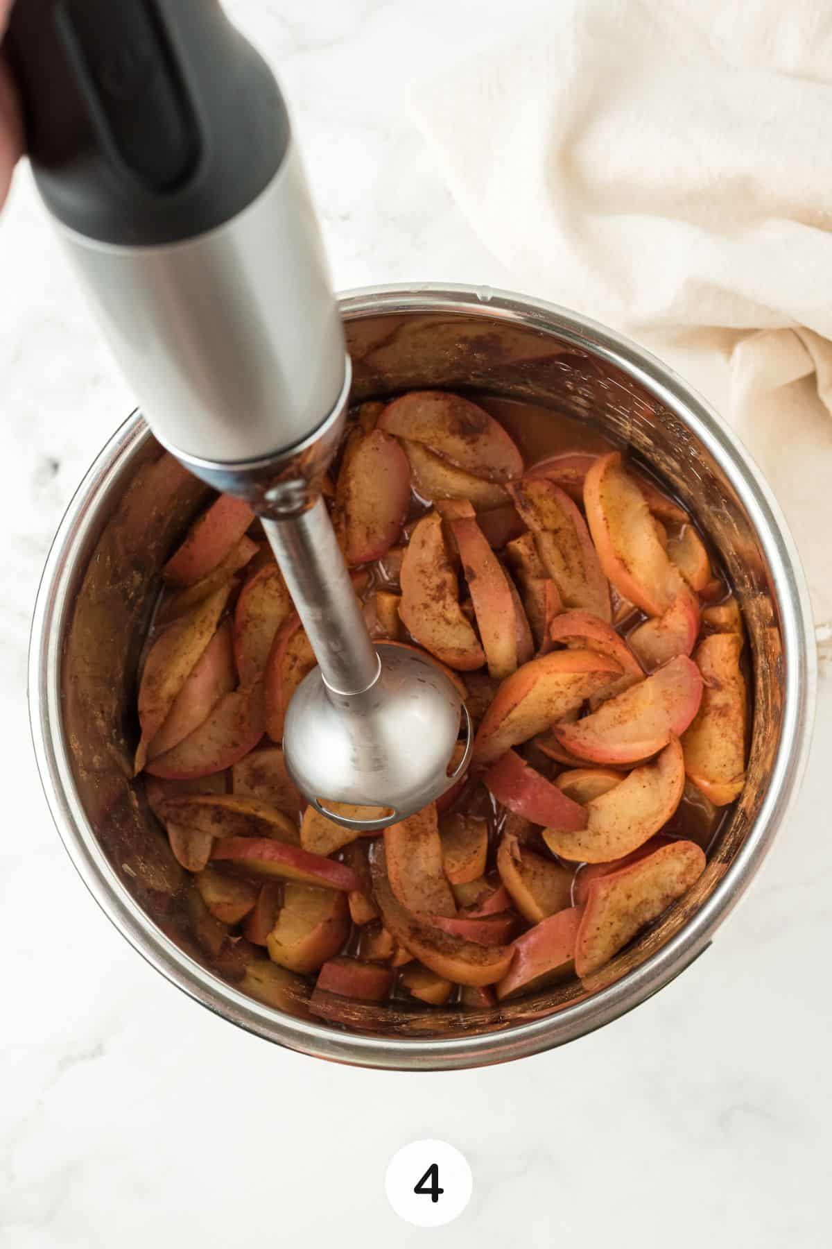 using hand immersion blender on cooked apples.