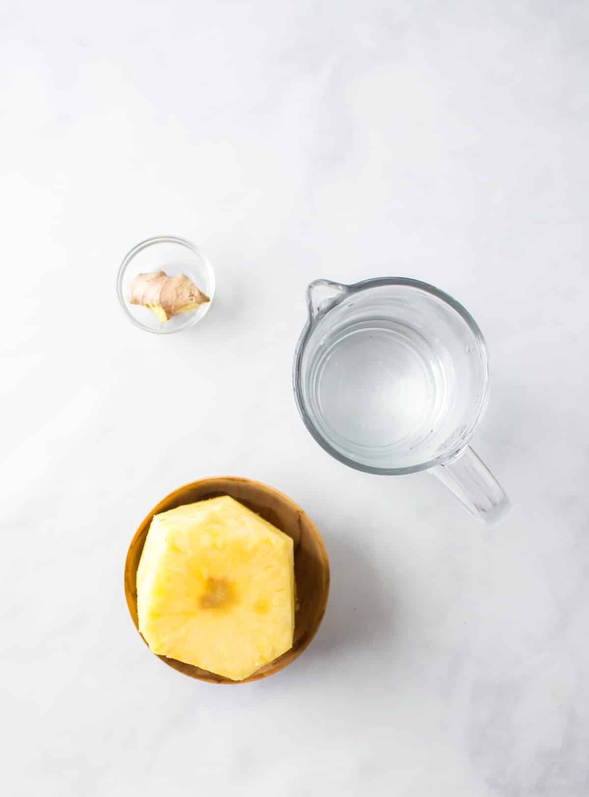 ingredients for pineapple ginger juice on table.