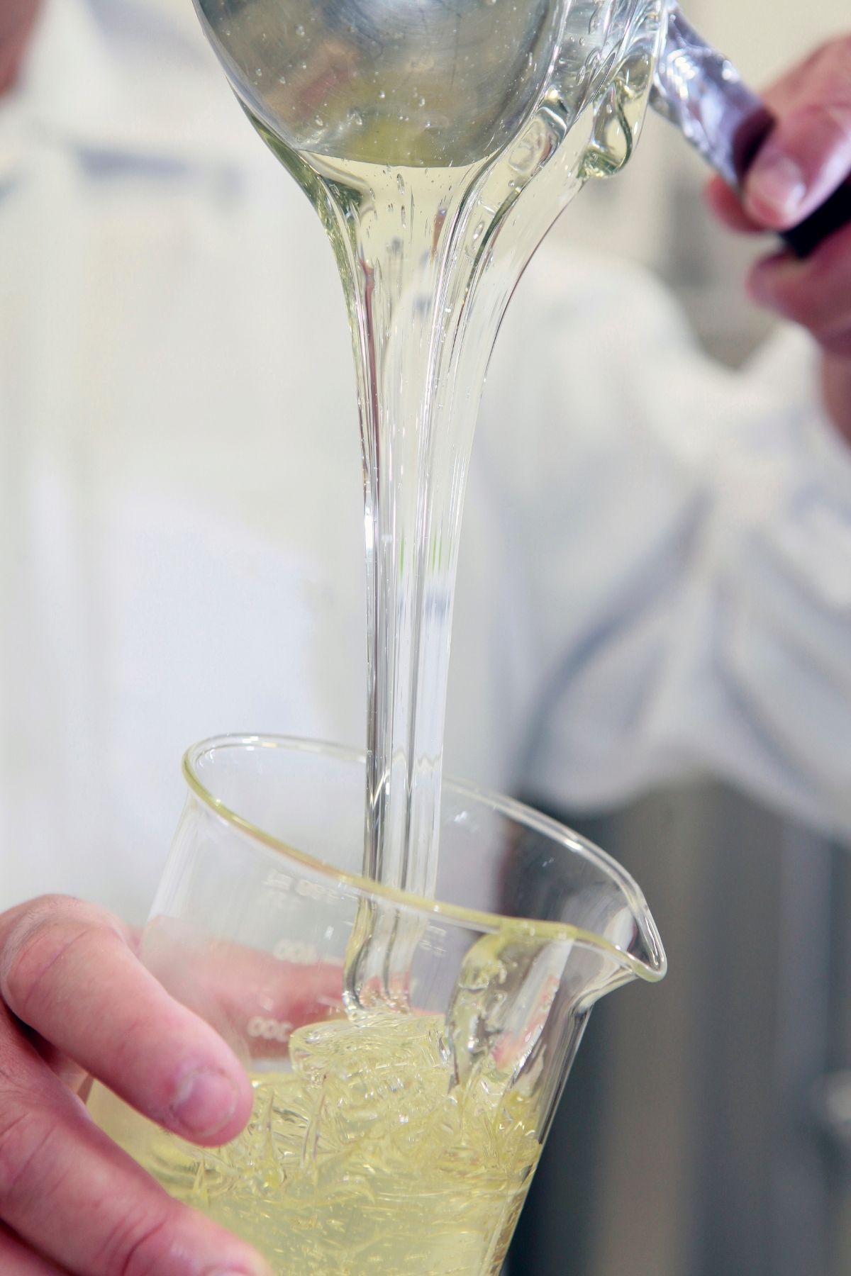 high fructose corn syrup being poured into a beaker.