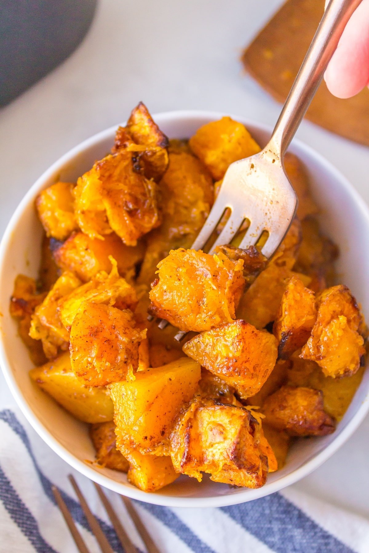 air fryer butternut squash cubes bite shot with fork.