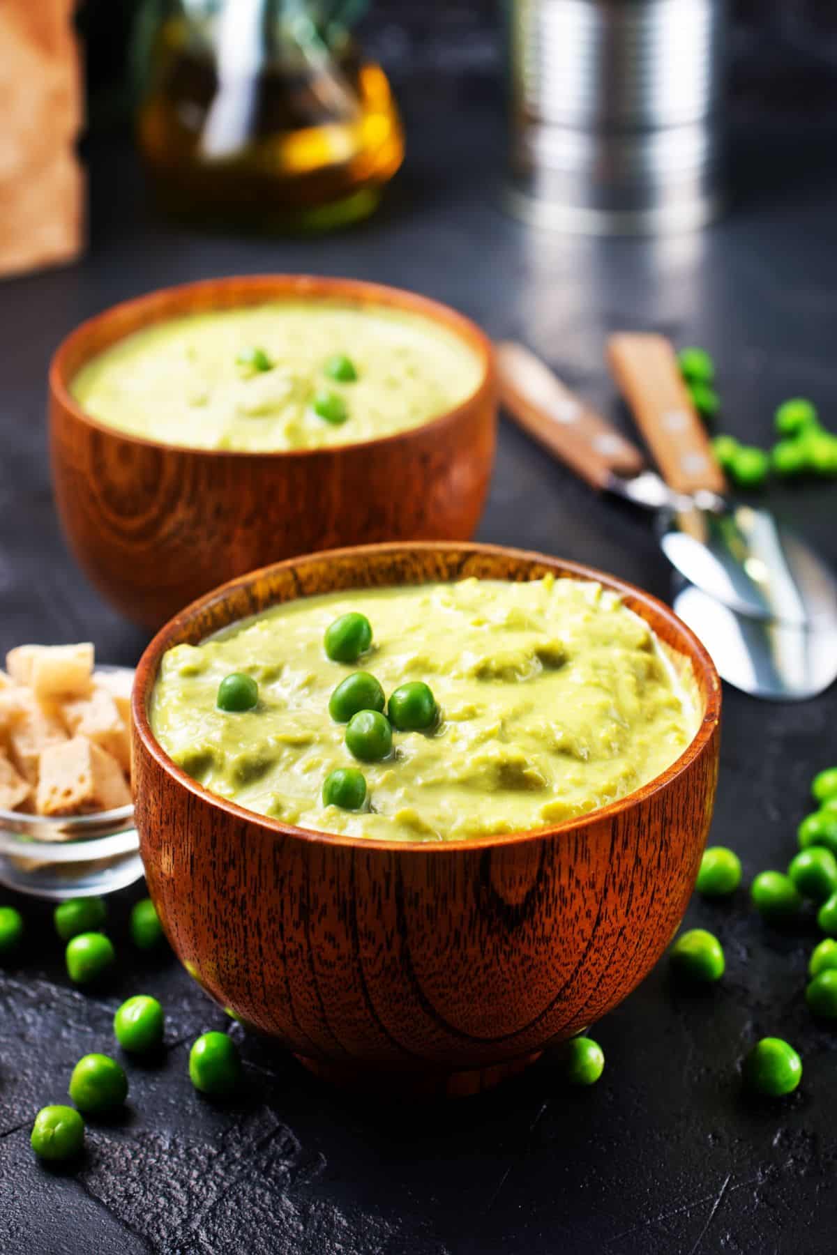 mashed peas in wooden bowl.