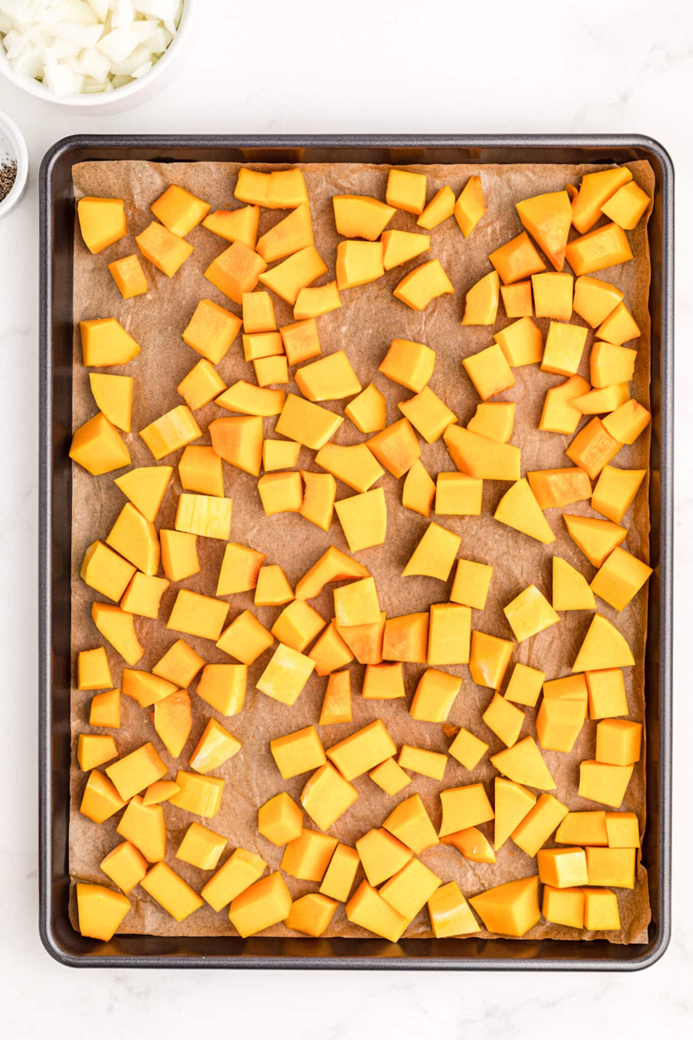 chopped butternut squash on baking sheet.