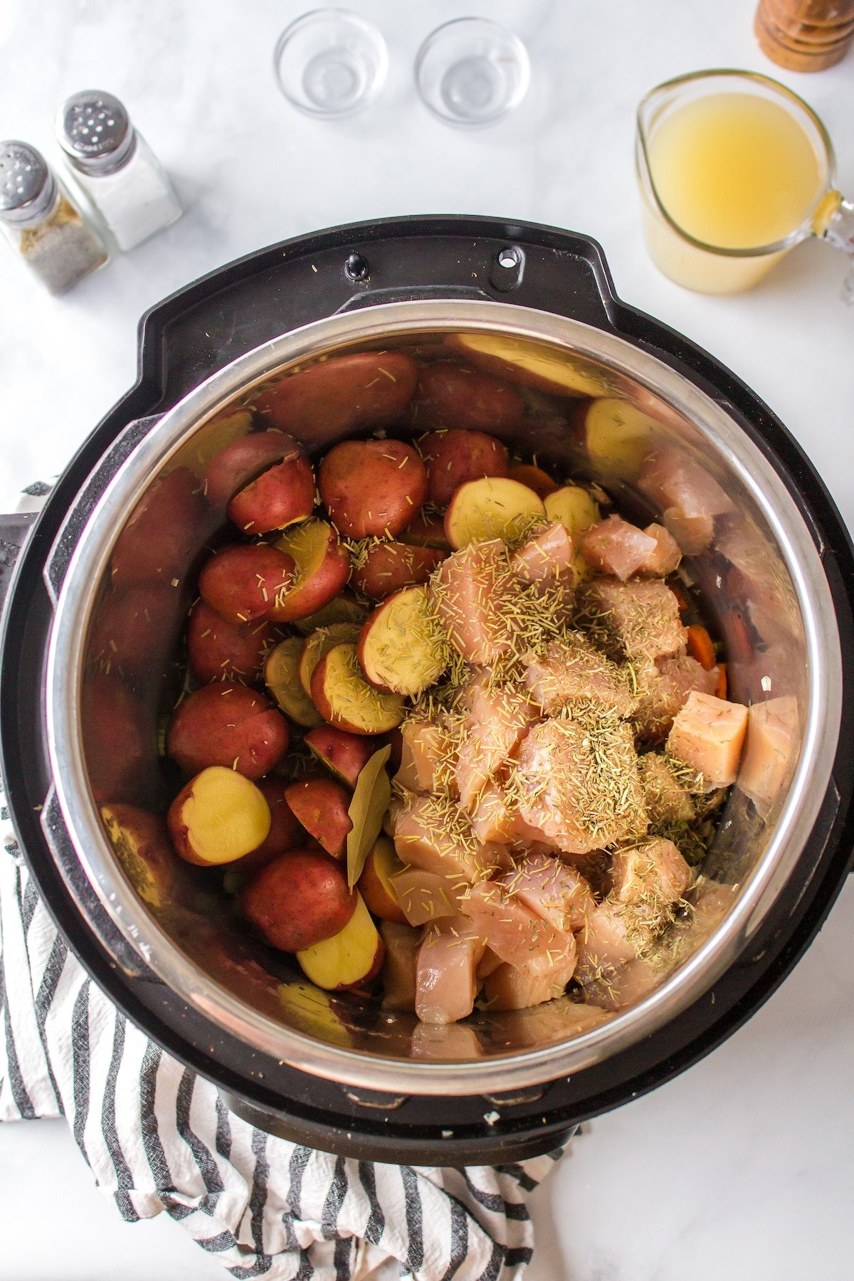 chicken and potatoes added to pot for cooking.