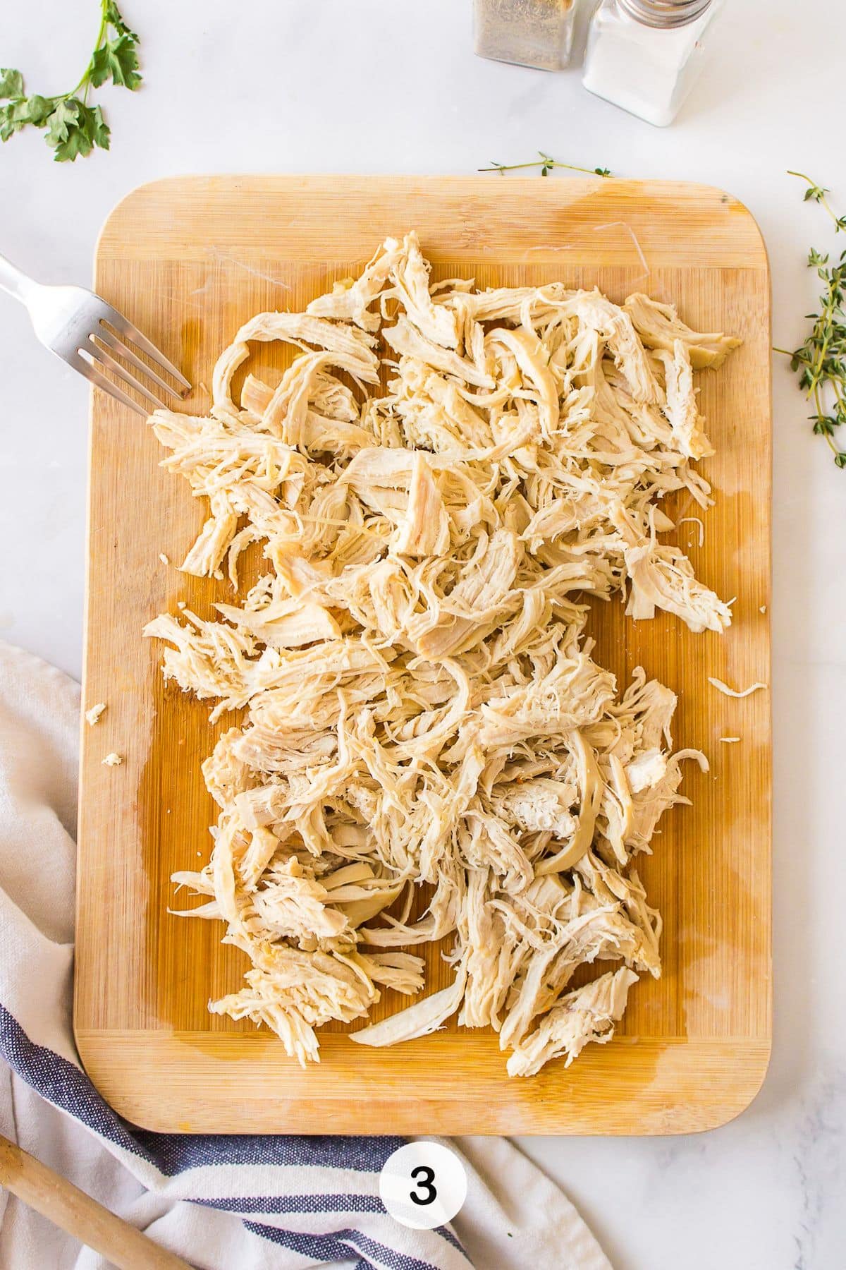 shredded chicken on cutting board.