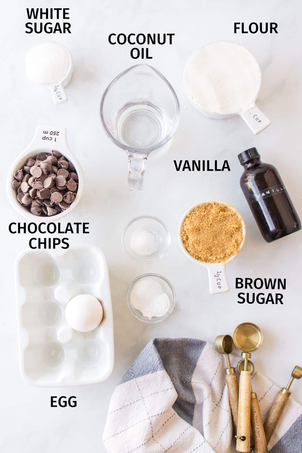 ingredients for chocolate chip cookies without butter on a white counter.