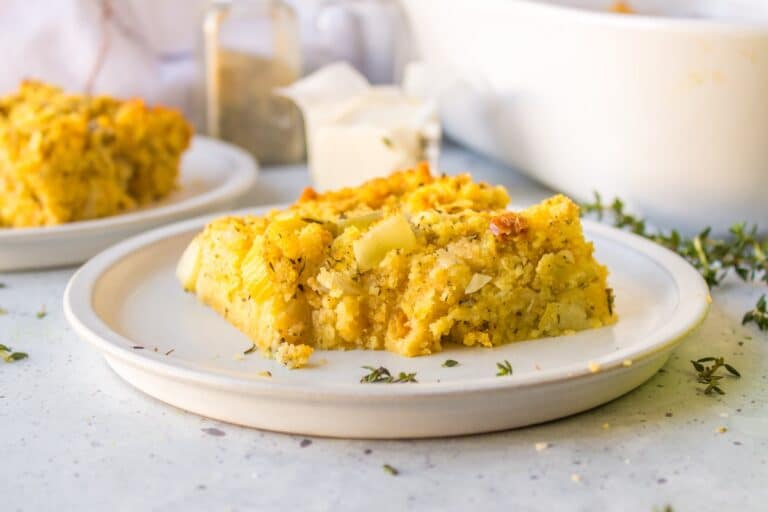 a slice or gluten-free cornbread stuffing on a white plate.