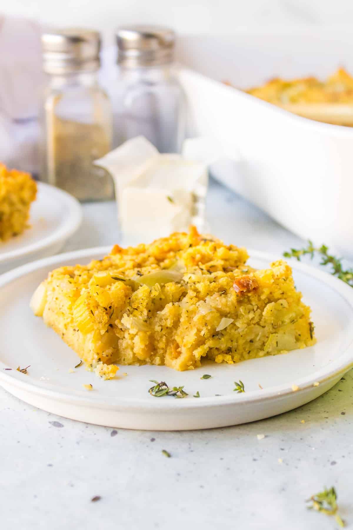 a slice or gluten-free cornbread stuffing on a white plate.