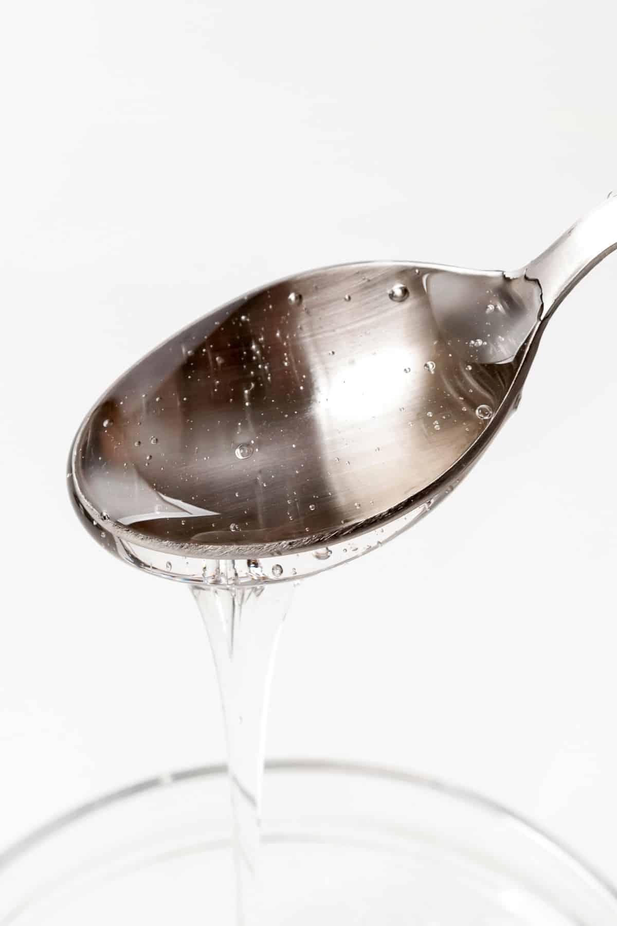 malt syrup pouring out of a spoon.