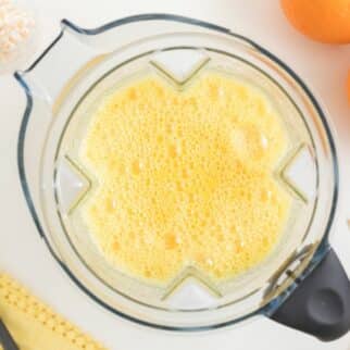 blended orange juice inside vitamix pitcher.