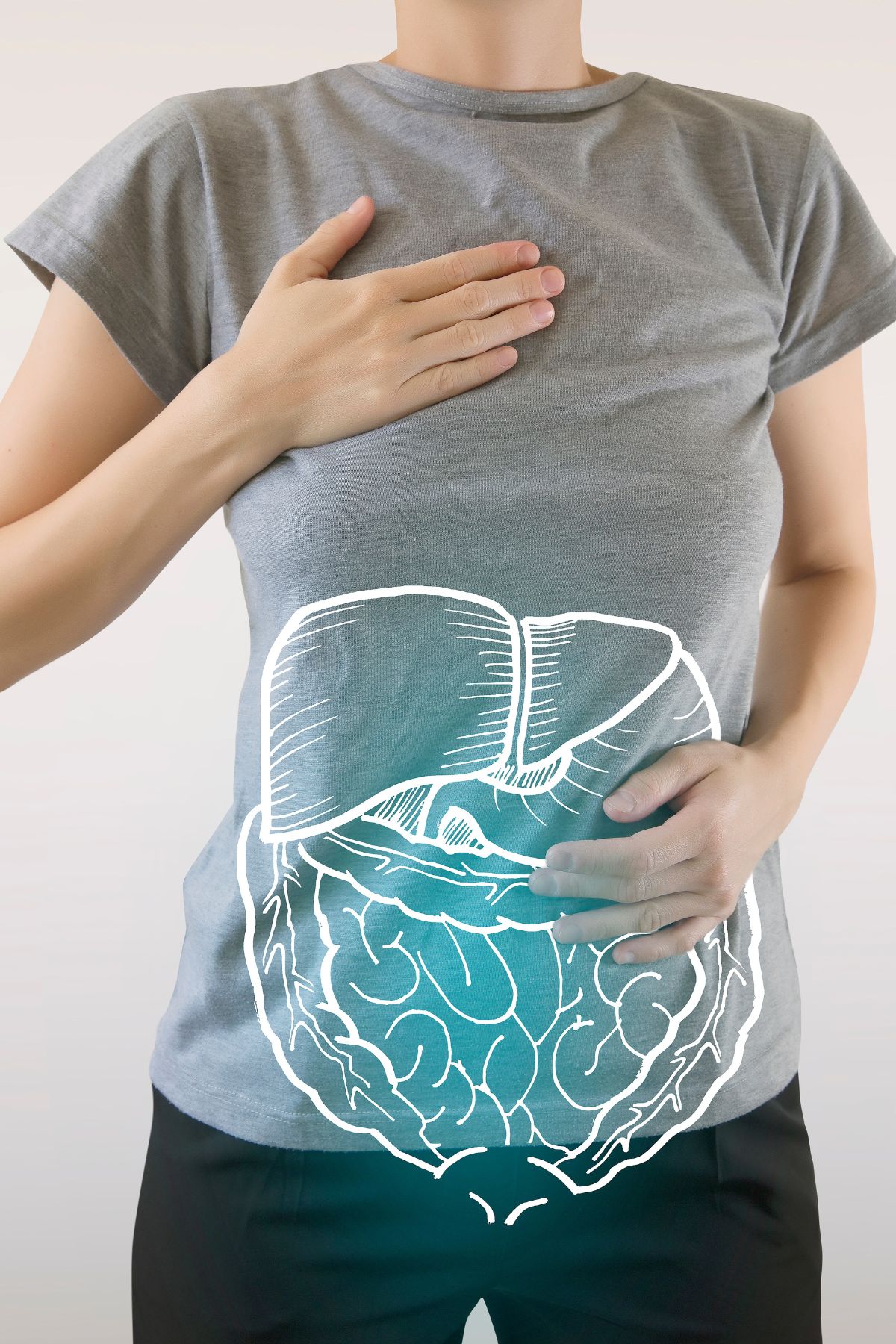 a woman holding her stomach, which has a illustration of her digestive tract.