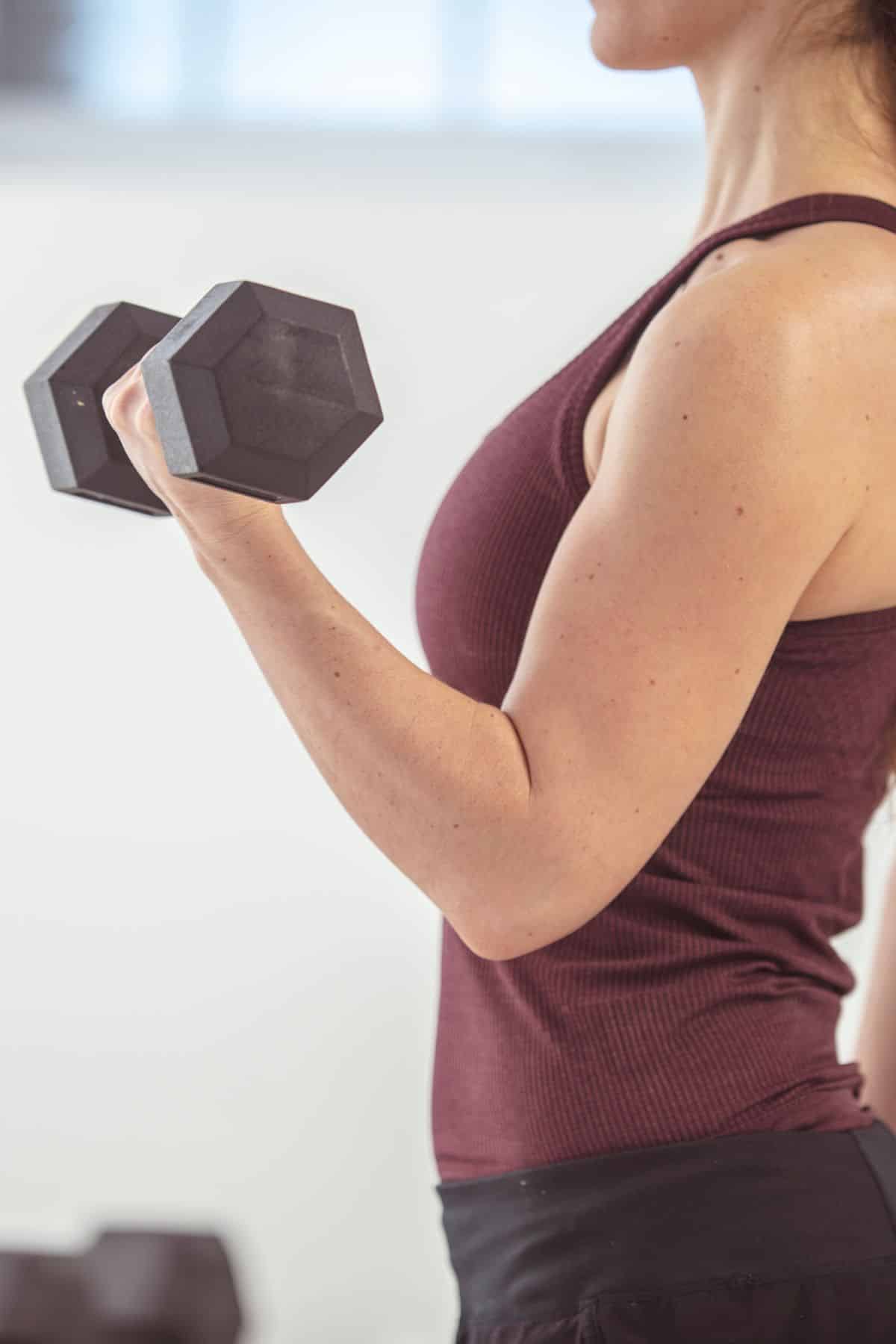 a woman doing a bicep curl.