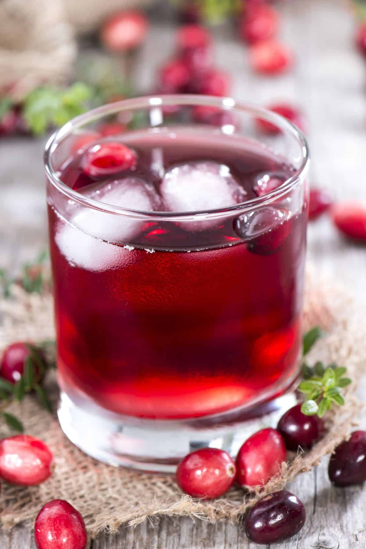 a glass of cranberry pineapple juice with ice.