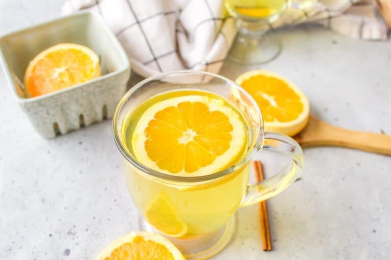 a glass mug of orange peel tea.