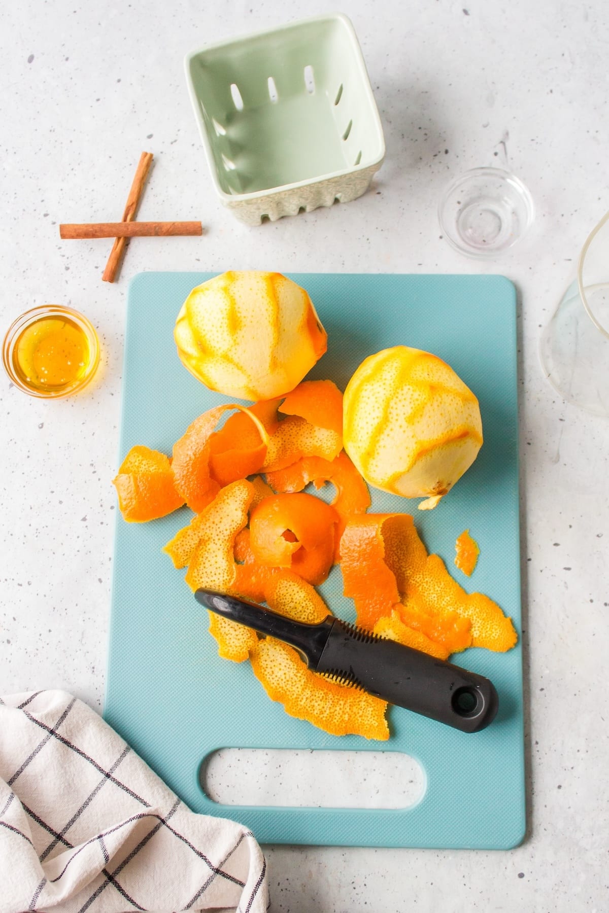 two oranges peeled on a cutting board.