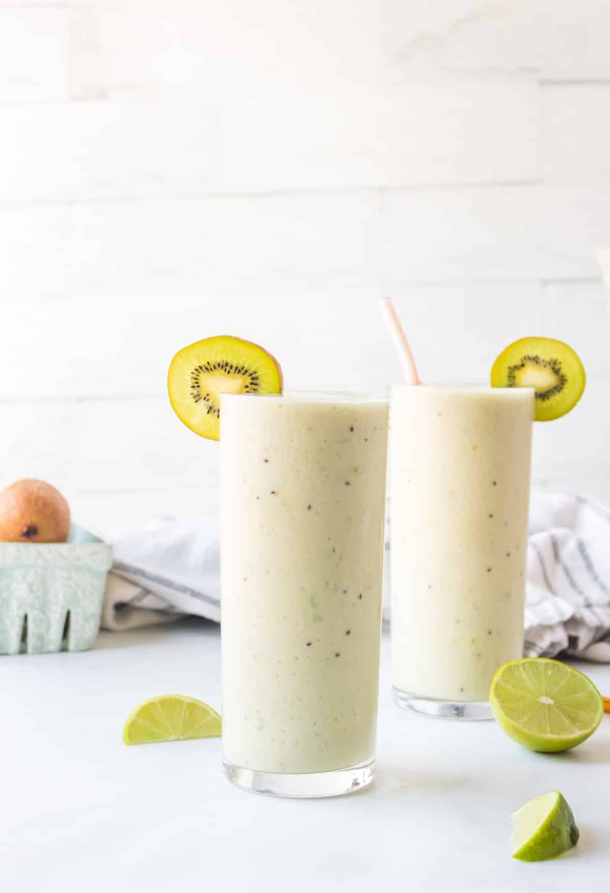 Gut Health Smoothie in glasses with slices of kiwi.