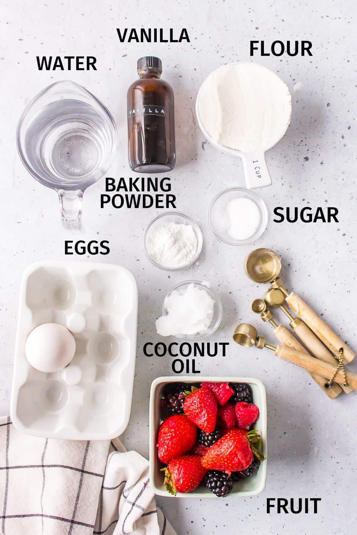 ingredients for pancakes without milk on a white counter.