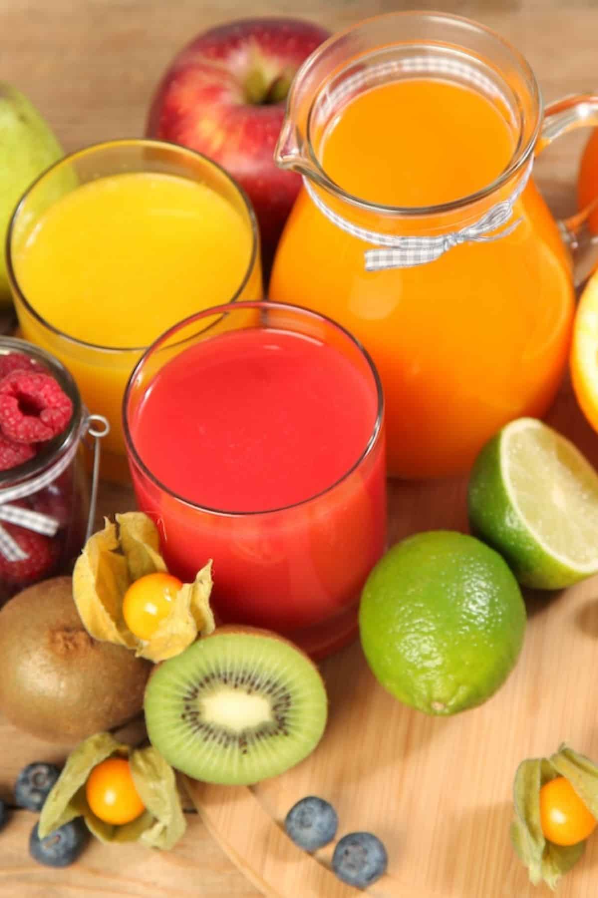 colorful selection of fruit juices on table.