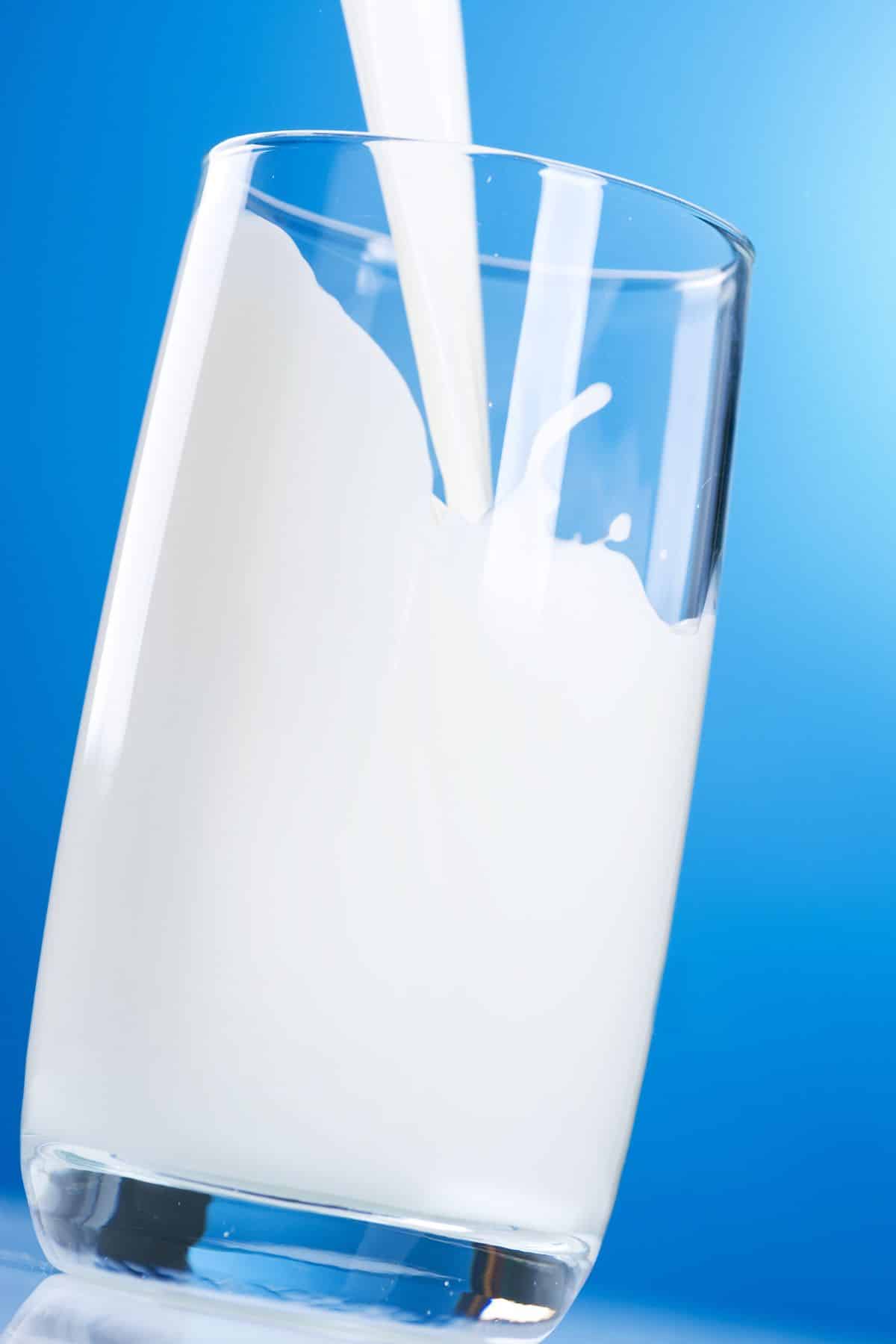 milk being poured into a glass.