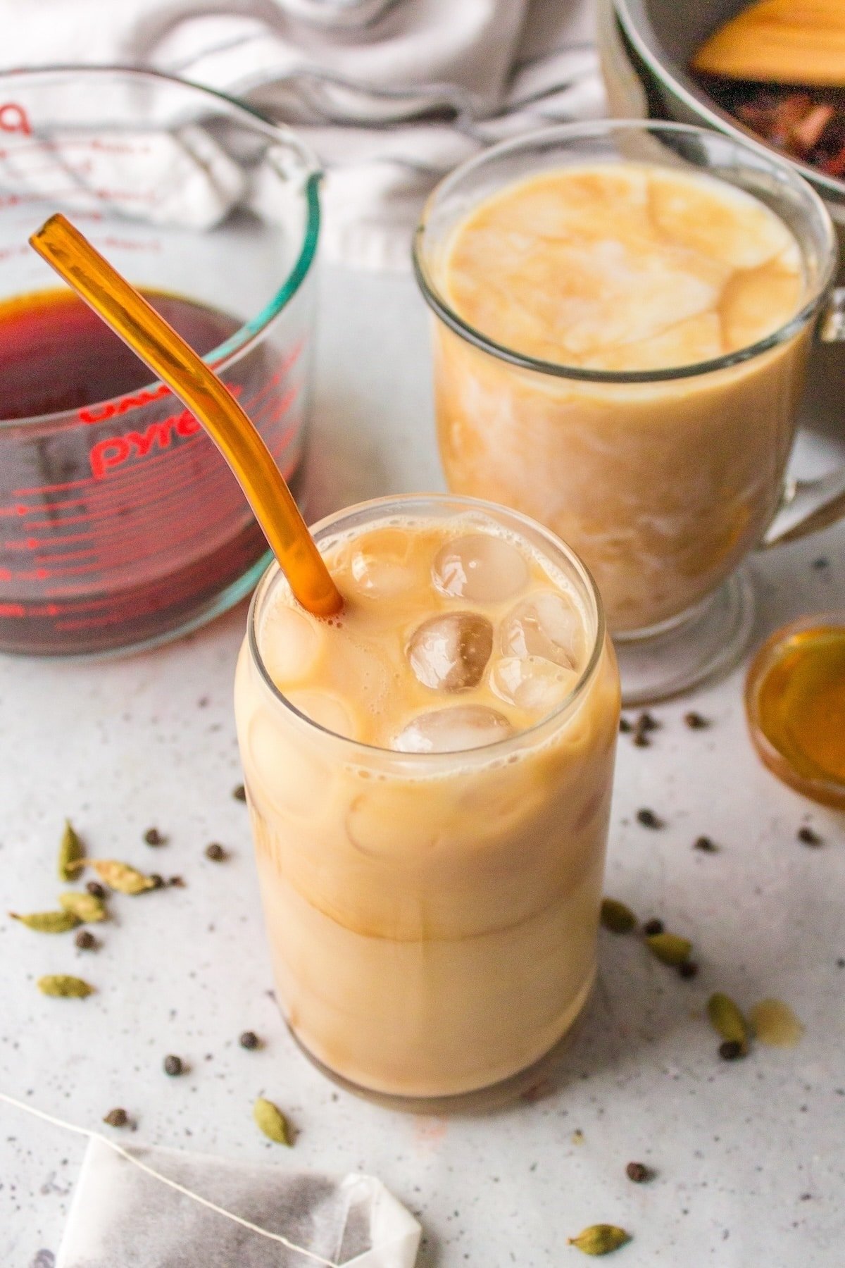 chai tea in a glass with a straw.