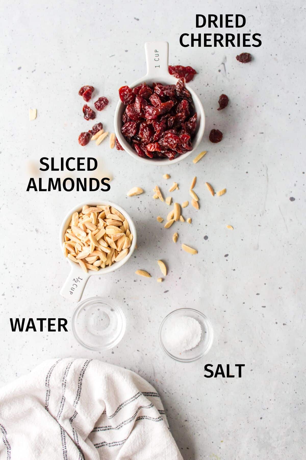 ingredients for cherry almond bars on a white counter.