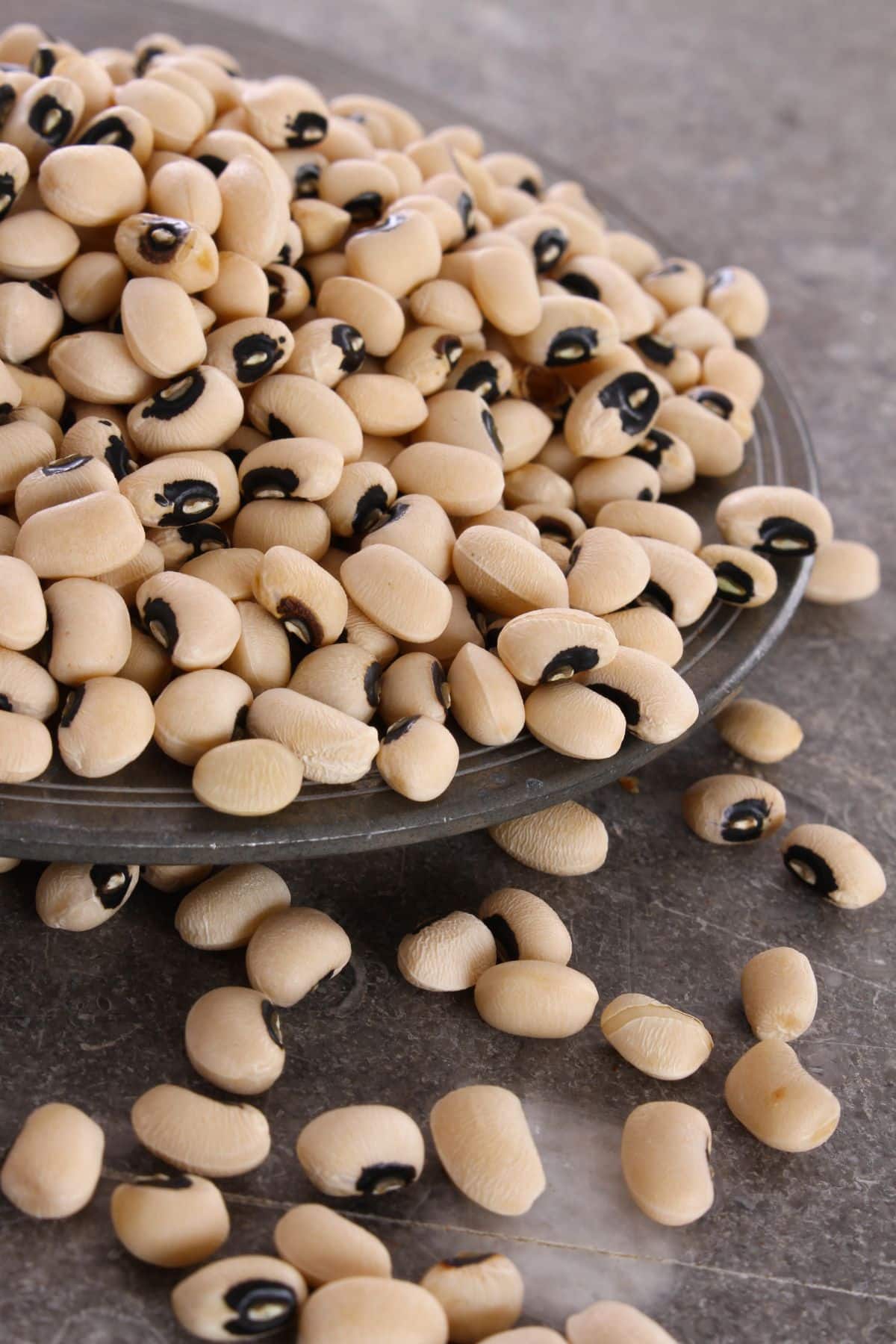 black eyed peas spilling off of a plate.