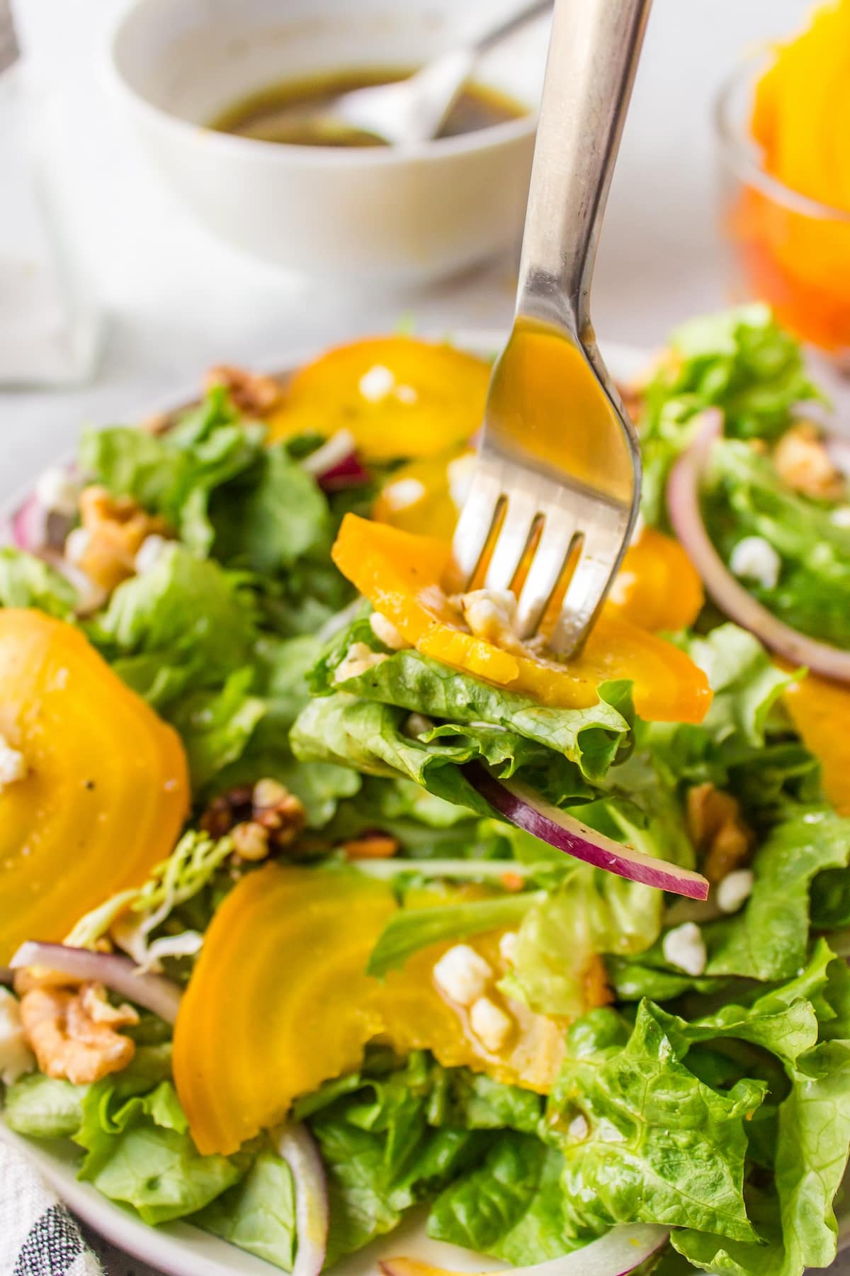 a bite of golden beet salad on a fork.