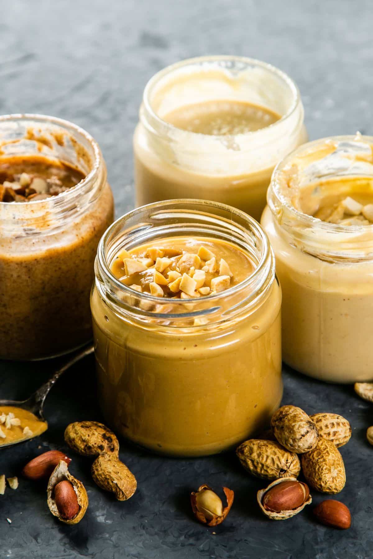 a variety of nut butters in jars.