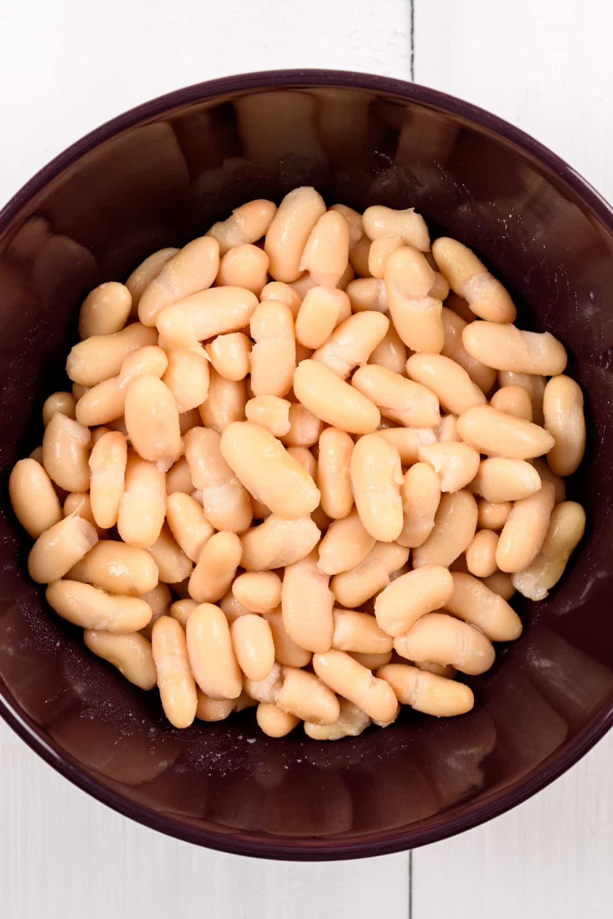 white beans in a brown bowl.