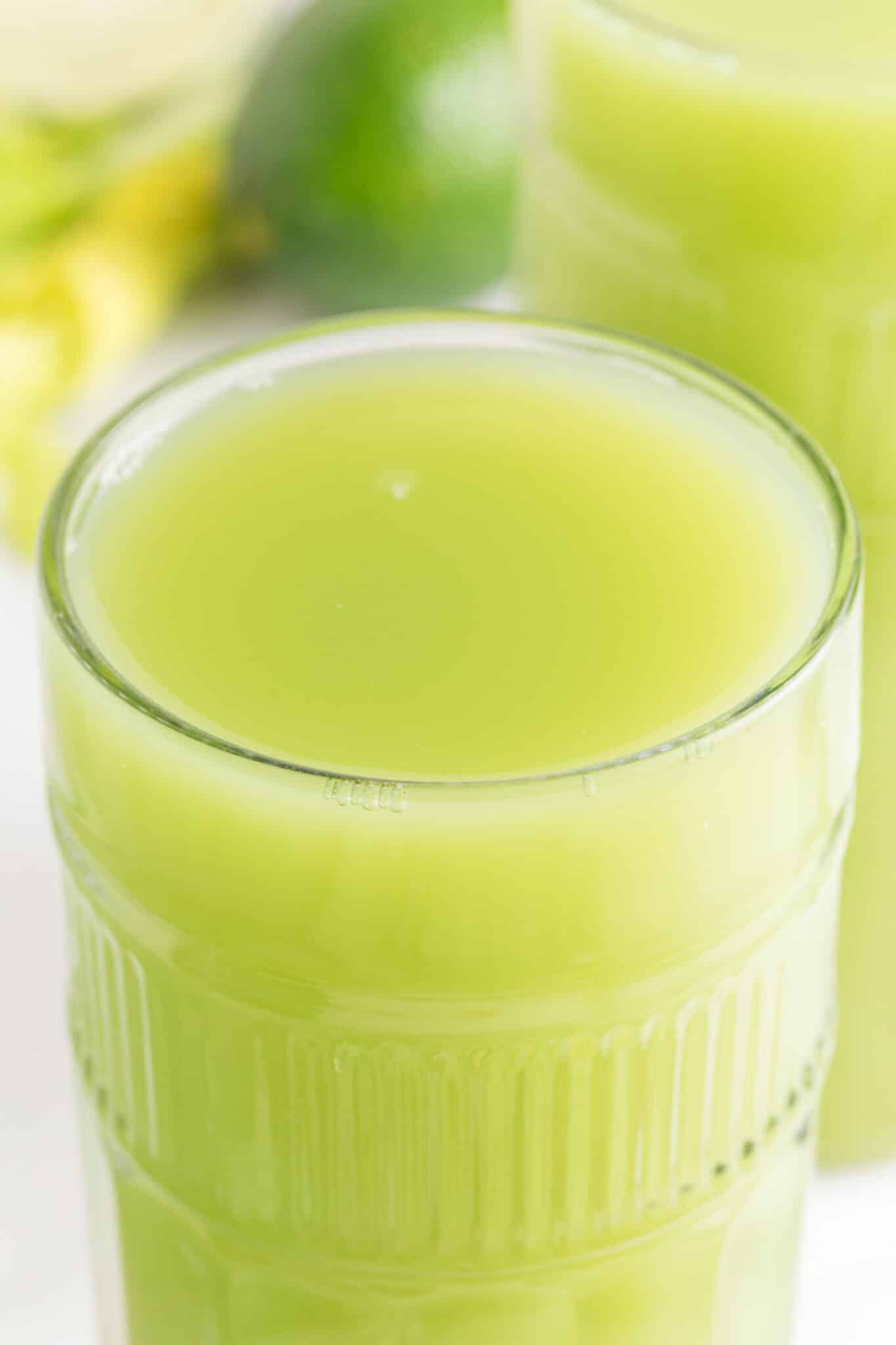 glass of fresh celery juice on table.