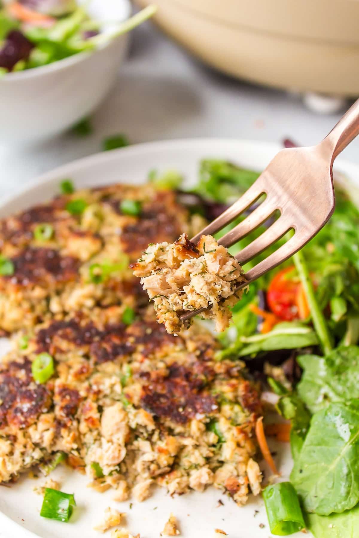 a bite of gluten-free salmon cakes on a fork.