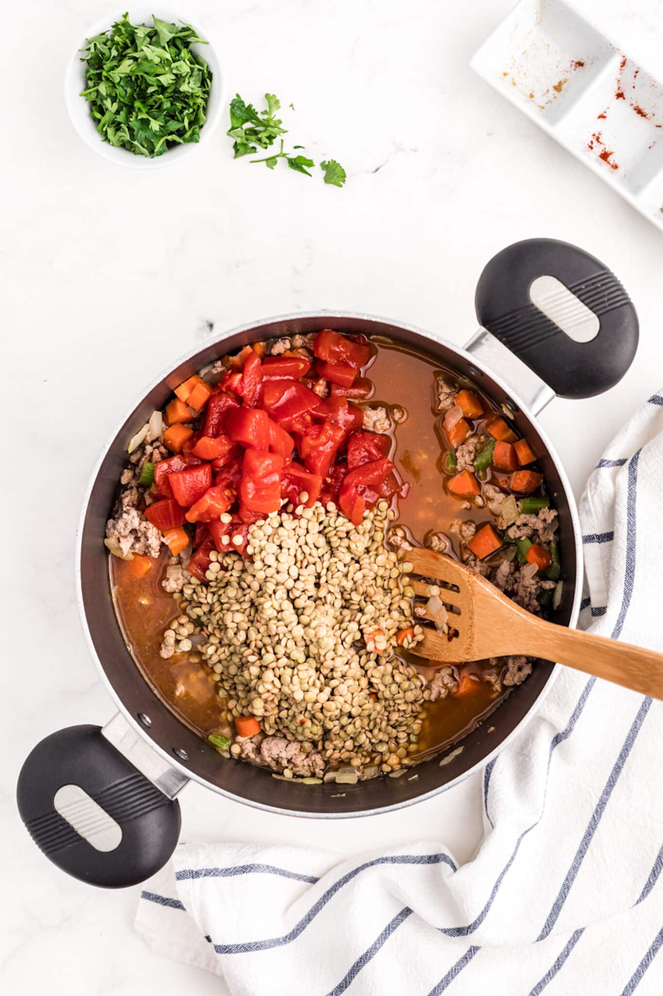 adding tomatoes and lentils.