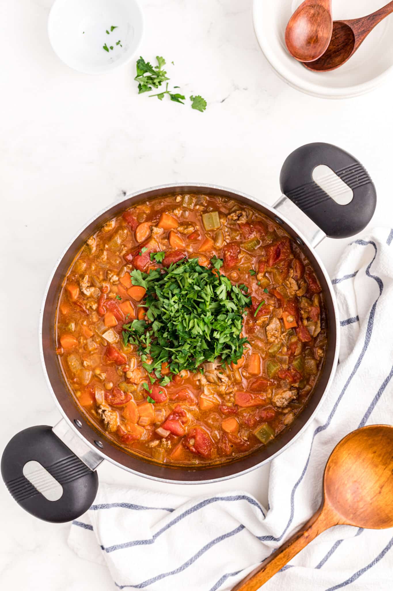 stirring fresh parsley into turkey lentil soup.