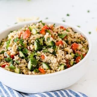 white bowl with quinoa veggie salad.